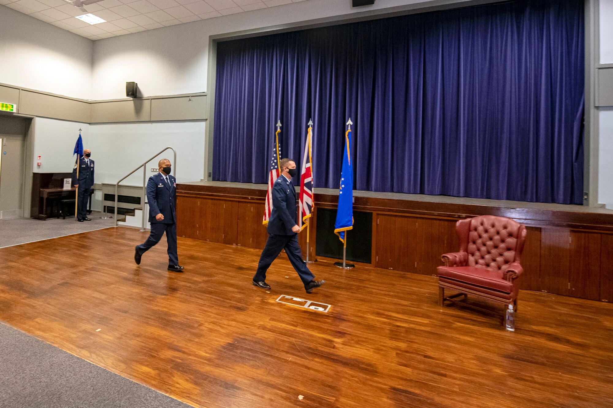 U.S. Air Force Col. Jon T. Hanah (right), 422d Air Base Group commander, and Lt. Col. Dino Quijano (left), 422d Medical Squadron incoming commander, enter as the official party during an assumption of command ceremony, at RAF Croughton, England, July 7, 2020. Quijano previously served as the 11th Medical Operations Squadron Family Health Clinic Flight Commander at Malcolm Grow Medical Clinics and Surgery Center, Joint Base Andrews, Md. (U.S Air Force photo by Senior Airman Eugene Oliver)