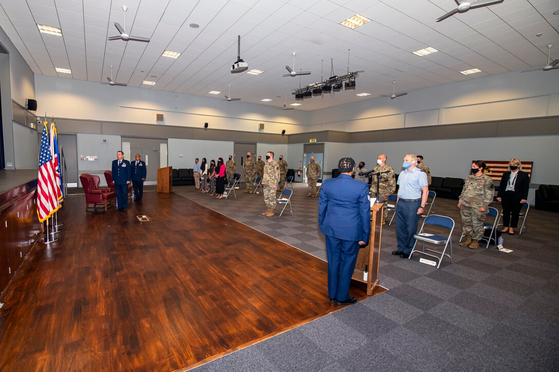 Airmen and guests from the 501st Combat Support Wing stand at attention, for the playing of the national anthem during the 422d Medical Squadron assumption of command ceremony, at RAF Croughton, England, July 7, 2020. An assumption of command is a military tradition that represents a formal assumption of a unit’s authority and responsibility by a commander. (U.S. Air Force photo by Senior Airman Eugene Oliver)