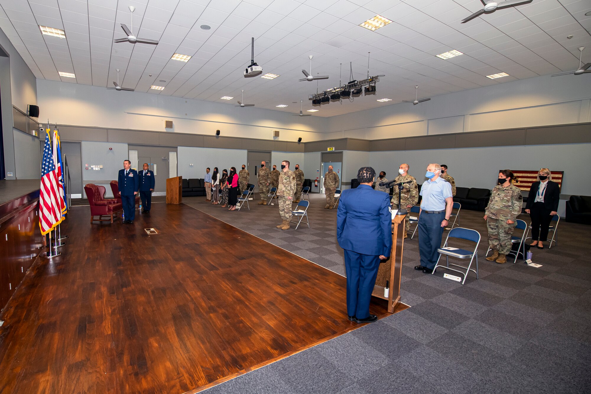 Airmen and guests from the 501st Combat Support Wing stand at attention, for the playing of the national anthem during the 422d Medical Squadron assumption of command ceremony, at RAF Croughton, England, July 7, 2020. An assumption of command is a military tradition that represents a formal assumption of a unit’s authority and responsibility by a commander. (U.S. Air Force photo by Senior Airman Eugene Oliver)