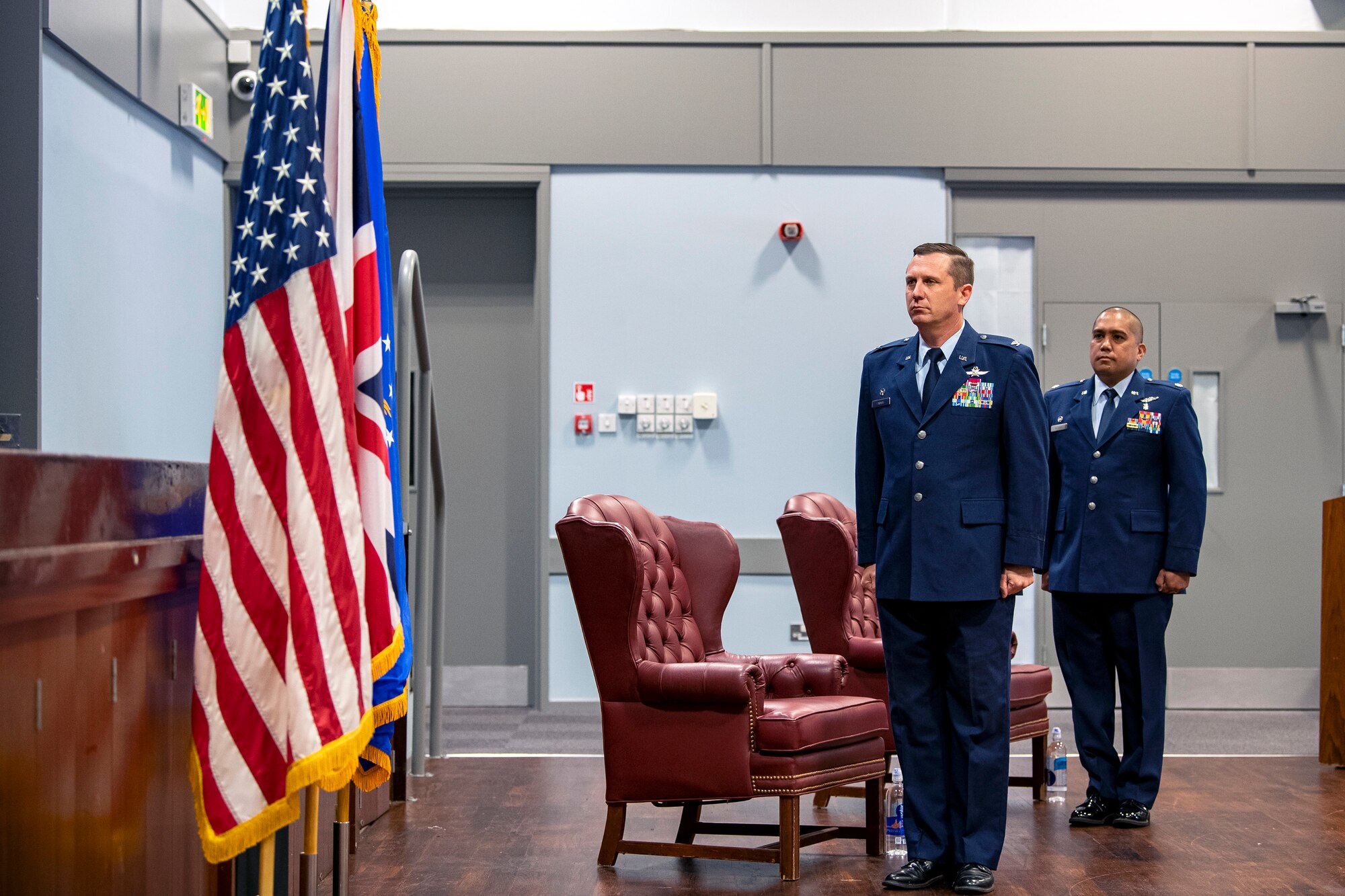U.S. Air Force Col. Jon T. Hanah (left), 422d Air Base Group commander, and U.S. Air Force Lt. Col. Dino Quijano (right), 422d Medical Squadron incoming commander stand at attention, for the playing of the national anthem, during an assumption of command ceremony at RAF Croughton, England, July 7, 2020. An assumption of command is a military tradition that represents a formal assumption of a unit’s authority and responsibility by a commander. (U.S. Air Force photo by Senior Airman Eugene Oliver)