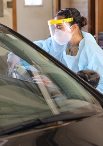 A Nebraska National Guard Soldier checks in a citizen before collecting a nasopharyngeal sample, June 10, 2020, at a mobile COVID-19 testing site in Nebraska City, Nebraska.