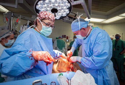 Members of the 555th Forward Surgical Team operate on a simulated trauma patient