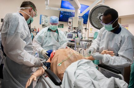 Members of the 555th Forward Surgical Team assess a simulated trauma patient during training with the Strategic Trauma Readiness Center of San Antonio