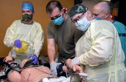 Members of the 555th Forward Surgical Team assess a simulated patient