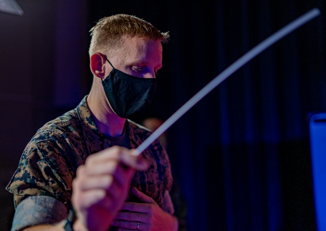 A U.S. Marine practices conducting prior to a combined performance with the Japan Ground Self-Defense Force 15th Brigade Band on June 18.