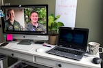 Maj, Marcus Mosher (left) and Maj. Nathan Moseley (right) participate in a video chat.