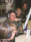A light moment as Col. David Goldfein, 49th Fighter Wing commander, Chief Master Sgt. Marjorie McNichols, 49th FW command chief, and Capt. Joel Stark, 49th FW Public Affairs, discuss Holloman events with KRSV-FM co-host Jean Vallance, during a live radio in Alamogordo, N.M., Aug. 29, 2007. (Courtesy photo)
