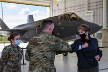 U.S. Air Force Master Sgt. Thomas Hulsart, a 354th Aircraft Maintenance Squadron F-35A Lightning II production superintendent, bumps elbows with Secretary of the Air Force Barbara M. Barrett after being coined at Eielson Air Force Base, Alaska, July 7, 2020. During her visit, Barrett talked with and listened to Eielson Airmen to learn more about how they contribute to the mission daily. (U.S. Air Force photo by Airman 1st Class Aaron Larue Guerrisky)