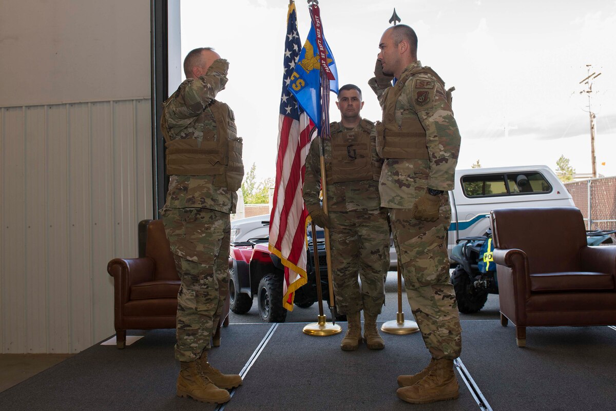 U.S. Air Force Maj. Samuel Waterman (right) renders a salute to Col. Chad Bondurant, the 354th Mission Support Group commander, upon assuming command of the 354th Security Forces Squadron (SFS) during a change of command ceremony at Eielson Air Force Base, Alaska, July 7, 2020.