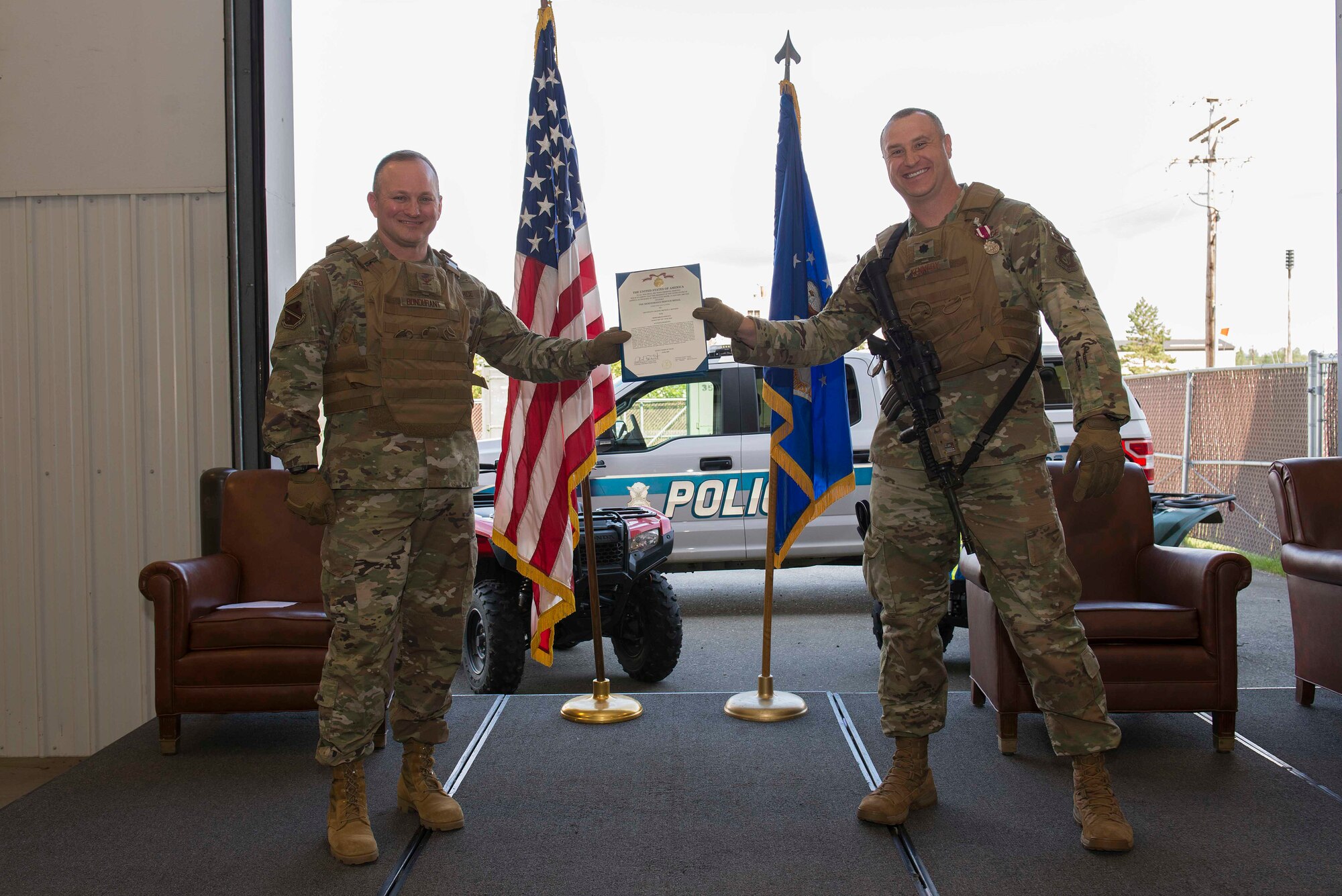 U.S. Air Force Lt. Col. Michael Kennedy (right) accepts the Meritorious Service Medal from Col. Chad Bondurant, the 354th Mission Support Group commander, upon relinquishing command of the 354th Security Forces Squadron during a change of command ceremony at Eielson Air Force Base, Alaska, July 7, 2020.