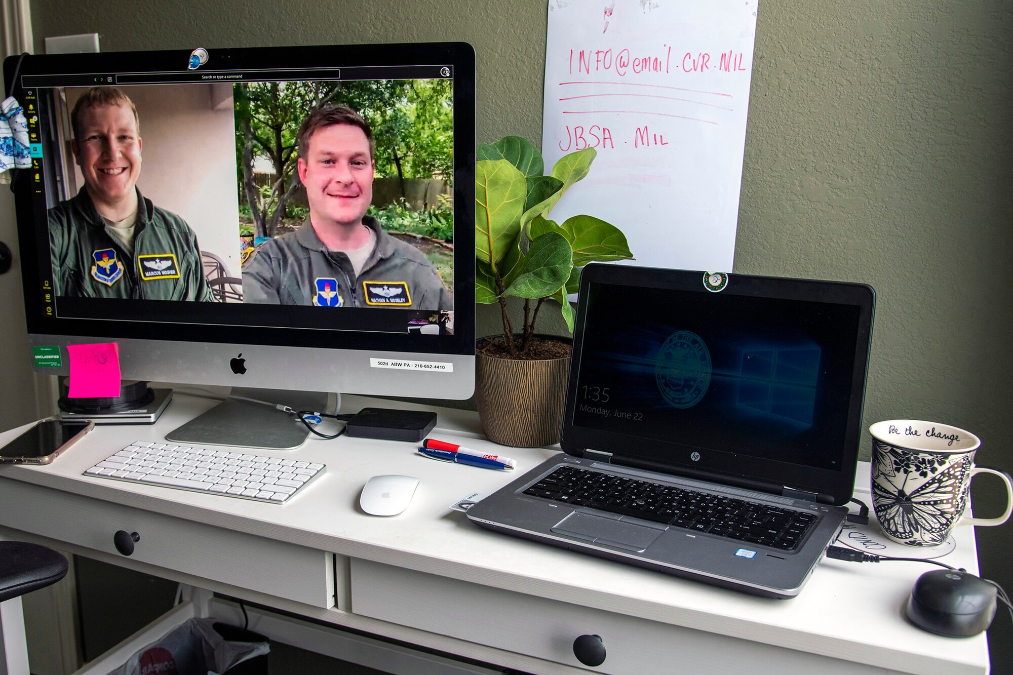 Maj, Marcus Mosher (left) and Maj. Nathan Moseley (right) participate in a video chat.