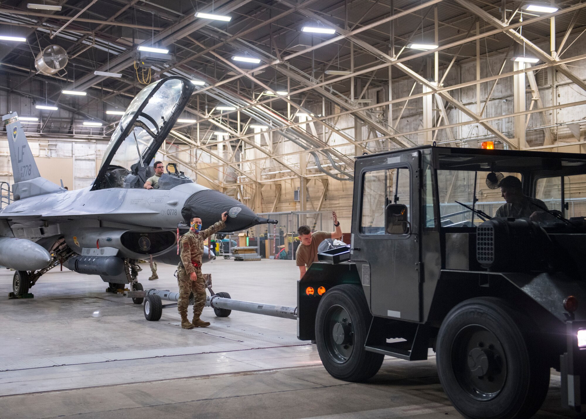 Airmen from the 310th Aircraft Maintenance Unit transport an F-16D Fighting Falcon to the flightline June 23, 2020, at Luke Air Force Base, Ariz.