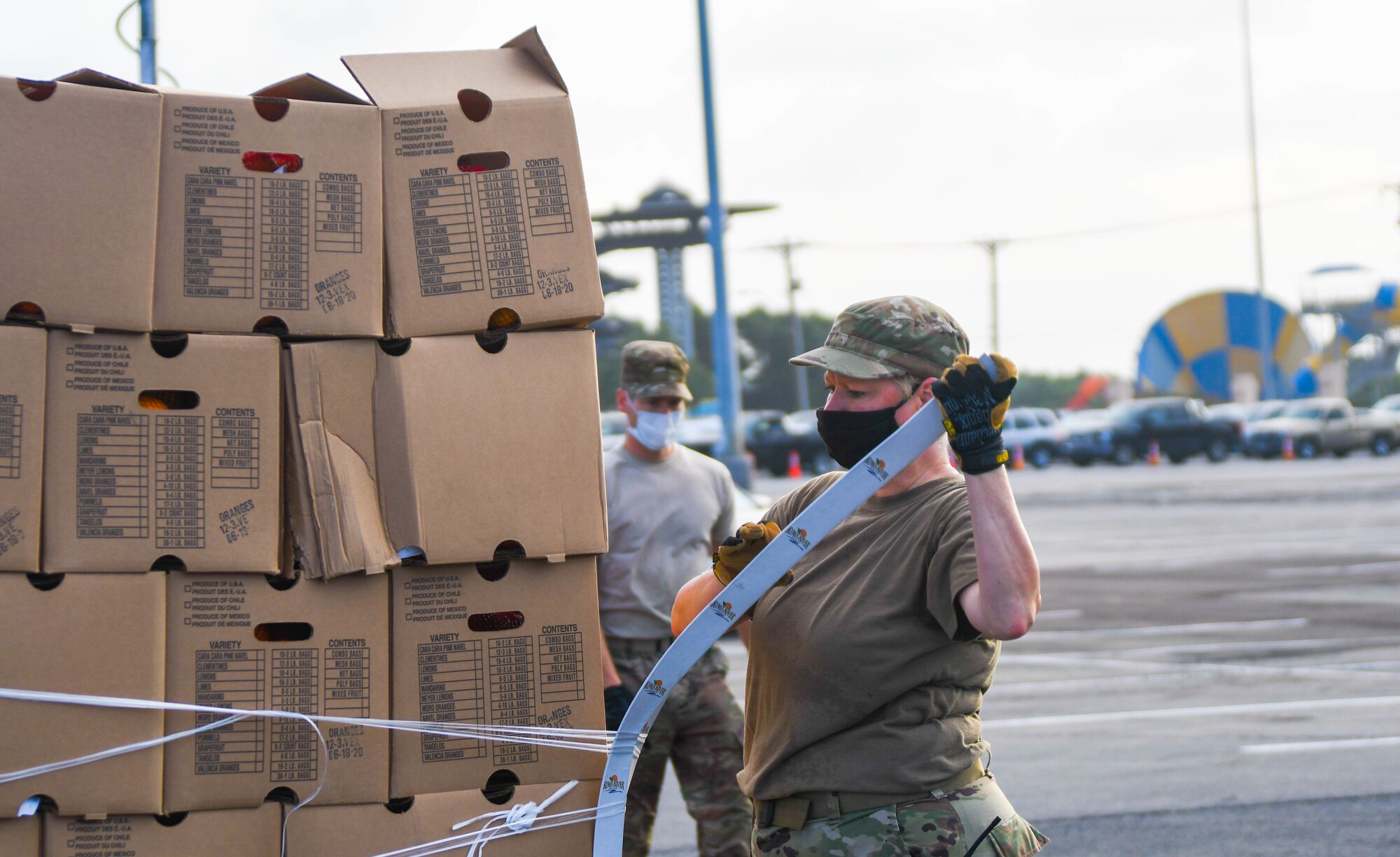 Guardsmen prepare family food boxes for distribution.