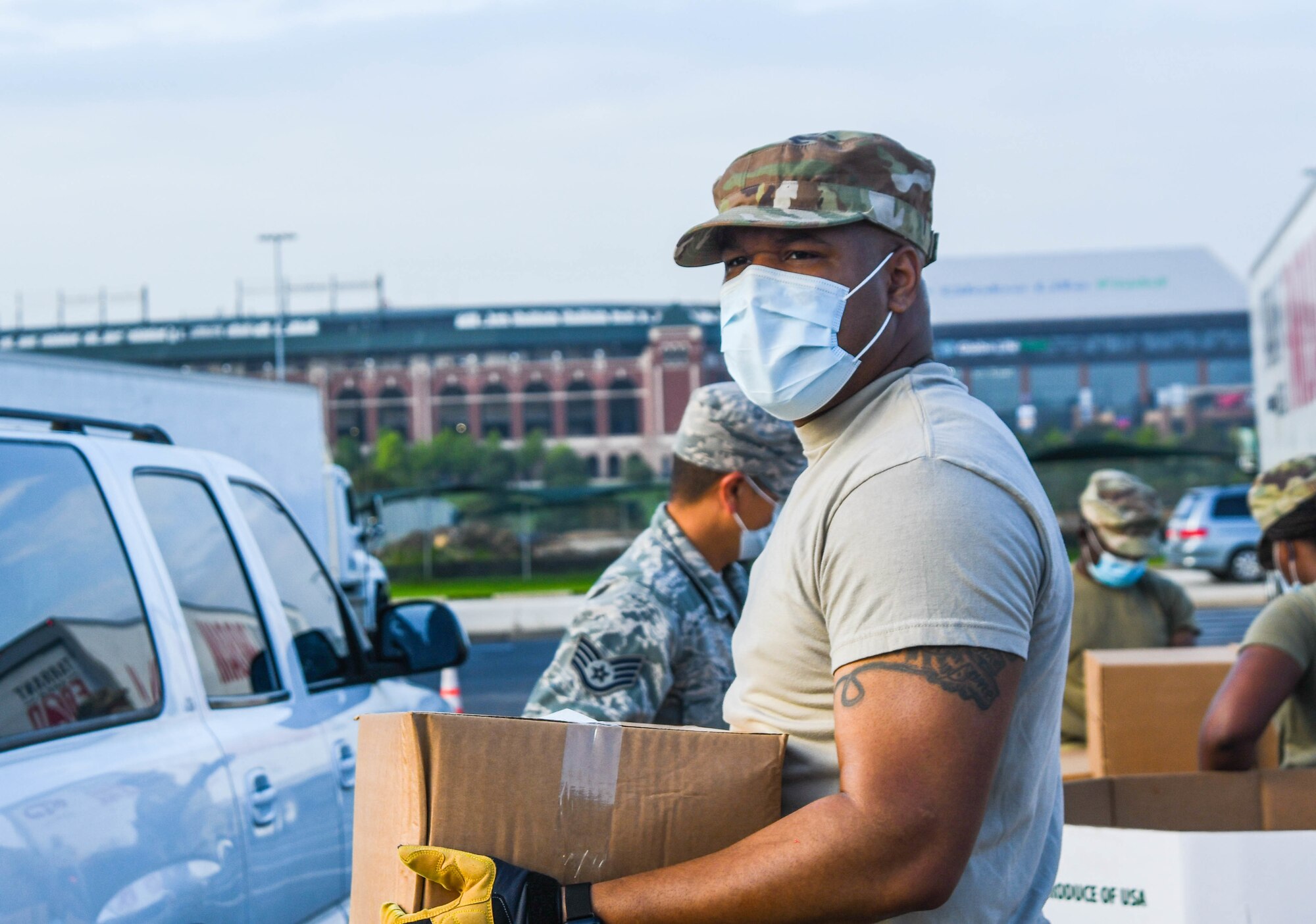 Guardsmen prepare family food boxes for distribution.