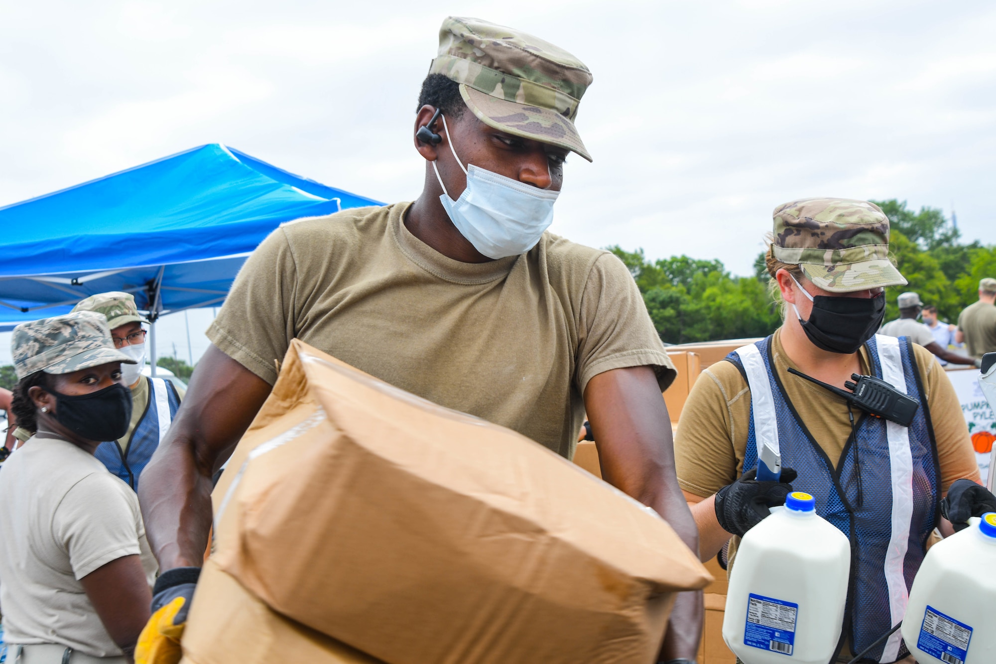 Guardsmen prepare family food boxes for distribution.