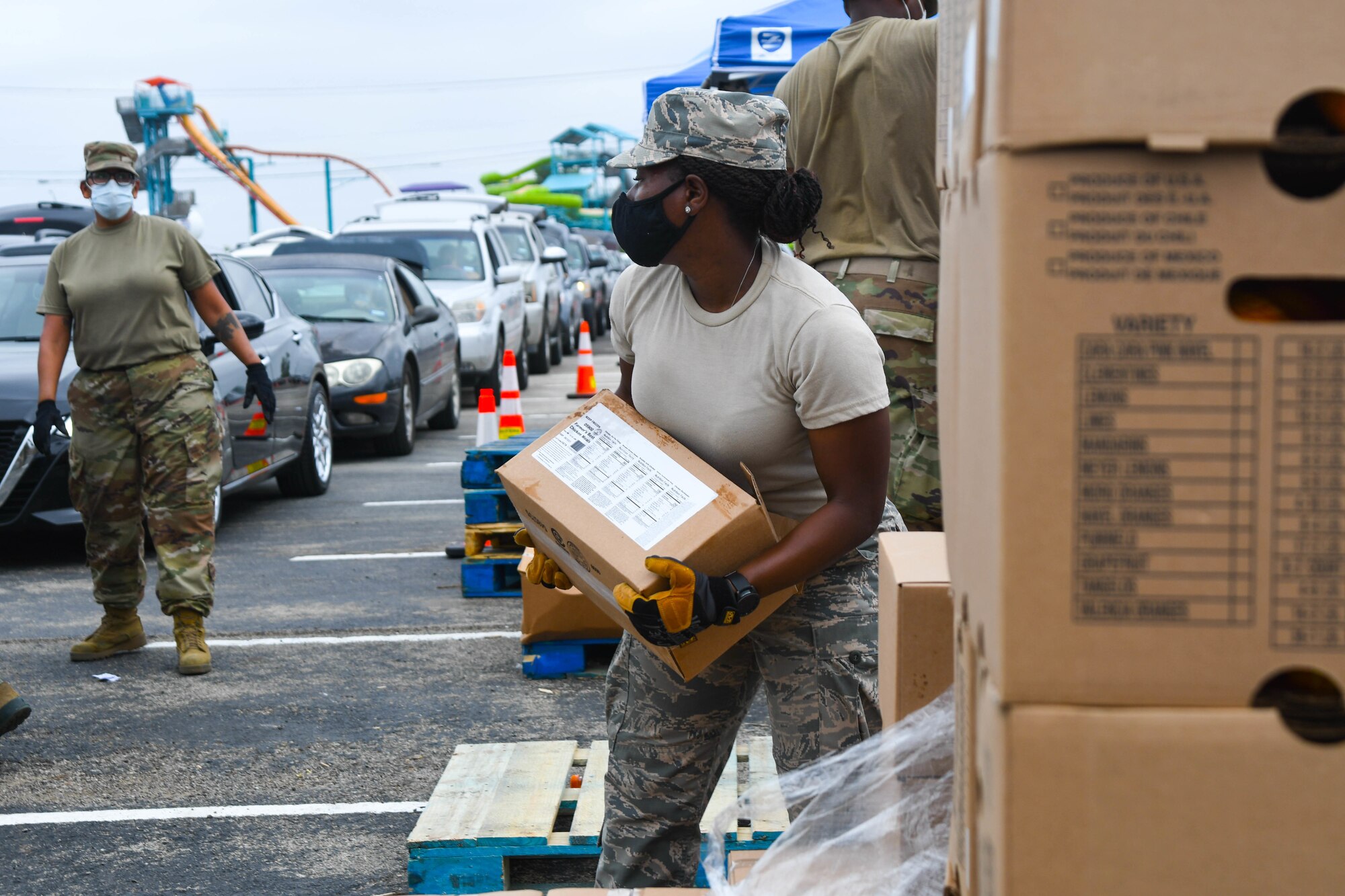Guardsmen prepare family food boxes for distribution.