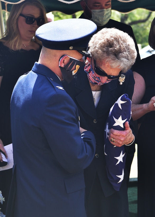 U.S. Air Force Col. Andres Nazario, 17th Training Wing commander, comforts widow JoAnne Powell during the late retired Col. Charles Powell’s funeral at the Fairmont Cemetery, San Angelo Texas, July 8, 2020. Powell served as a commander at Goodfellow Air Force Base and was a prominent figure within San Angelo.(U.S. Air Force photo by Staff Sgt. Chad Warren)