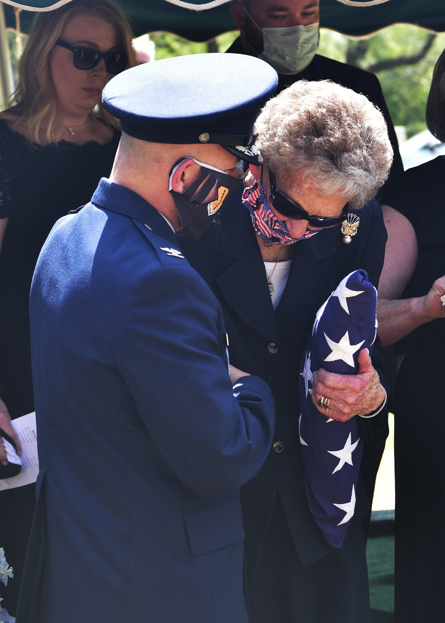U.S. Air Force Col. Andres Nazario, 17th Training Wing commander, comforts widow JoAnne Powell during the late retired Col. Charles Powell’s funeral at the Fairmont Cemetery, San Angelo Texas, July 8, 2020. Powell served as a commander at Goodfellow Air Force Base and was a prominent figure within San Angelo.(U.S. Air Force photo by Staff Sgt. Chad Warren)