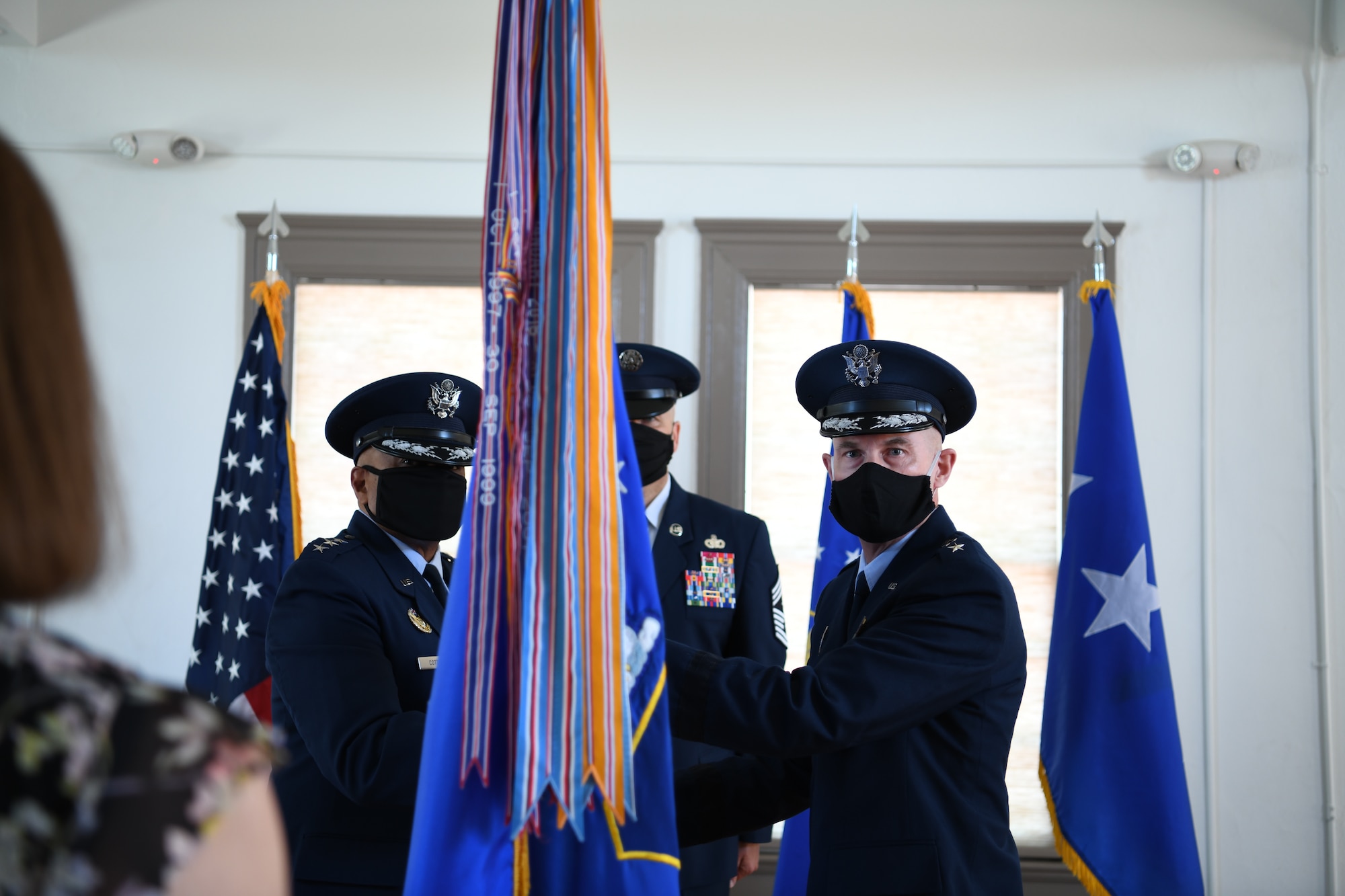Lt. Gen. Anthony Cotton, deputy commander of Air Force Global Strike Command, presents the guidon to Maj. Gen. Michael Lutton, the new 20th Air Force commander, during a change of command ceremony, 8 July, 2020, F. E. Warren Air Force Base, Wyo. During the ceremony, Maj. Gen. Michael J. Lutton took command of 20th Air Force from Maj. Gen. Ferdinand “Fred” B. Stoss. (U. S. Air Force photo by Senior Airman Braydon Williams)