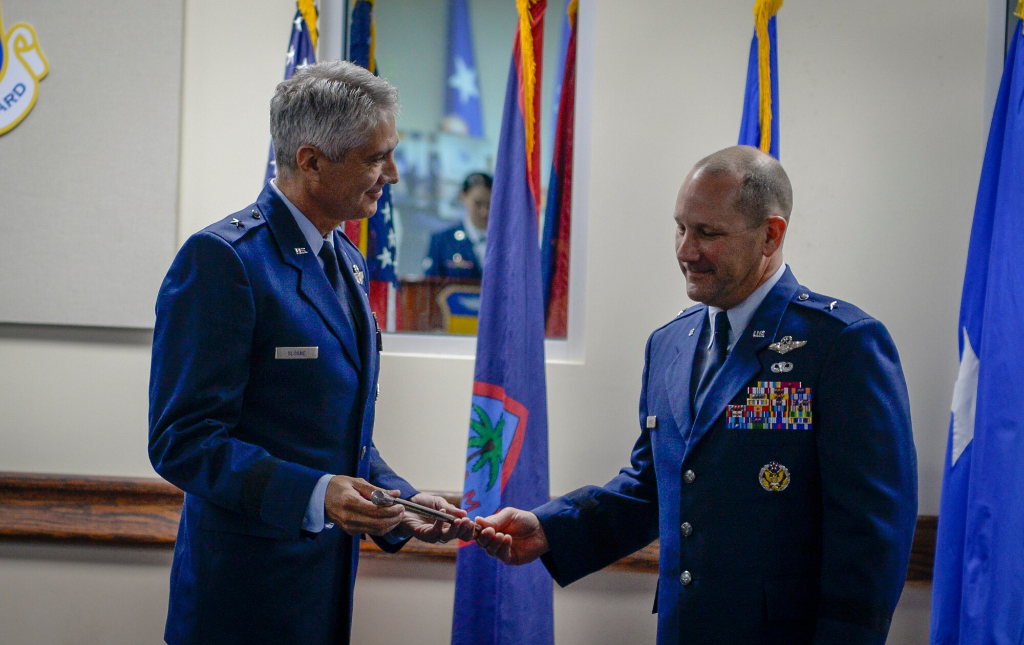 U.S. Air Force Brig. Gen. Gentry W. Boswell (right) passed the “swagger stick” to Brig. Gen. Jeremy T. Sloane during a change of command ceremony July 8, 2020, at Andersen Air Force Base, Guam.