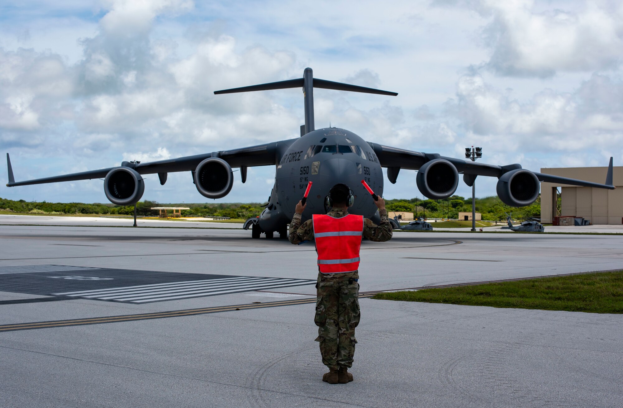 A C-17 Globemaster assigned to the 154th Wing, Hawaii Air National Guard, prepares to receive a post flight evaluation from Airmen assigned to the 734 Air Mobility Squadron after a Joint Forcible Entry Operation (JFEO) jump at Andersen Air Force Base, Guam, June 30.