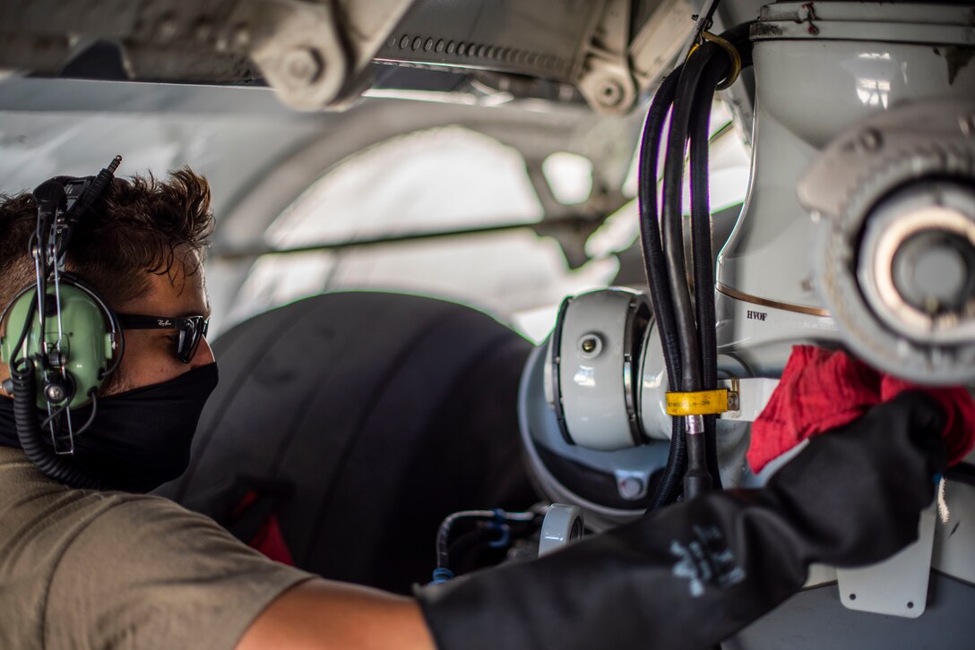 U.S. Air Force Staff Sgt. Tyler Garcia, 734 Air Mobility Squadron electrical and environmental systems craftsman, performs post-flight operations on a C-17 Globemaster assigned to the 154th Wing, Hawaii Air National Guard, after a Joint Forcible Entry Operation (JFEO) jump into Andersen Air Force Base, Guam, June 30.