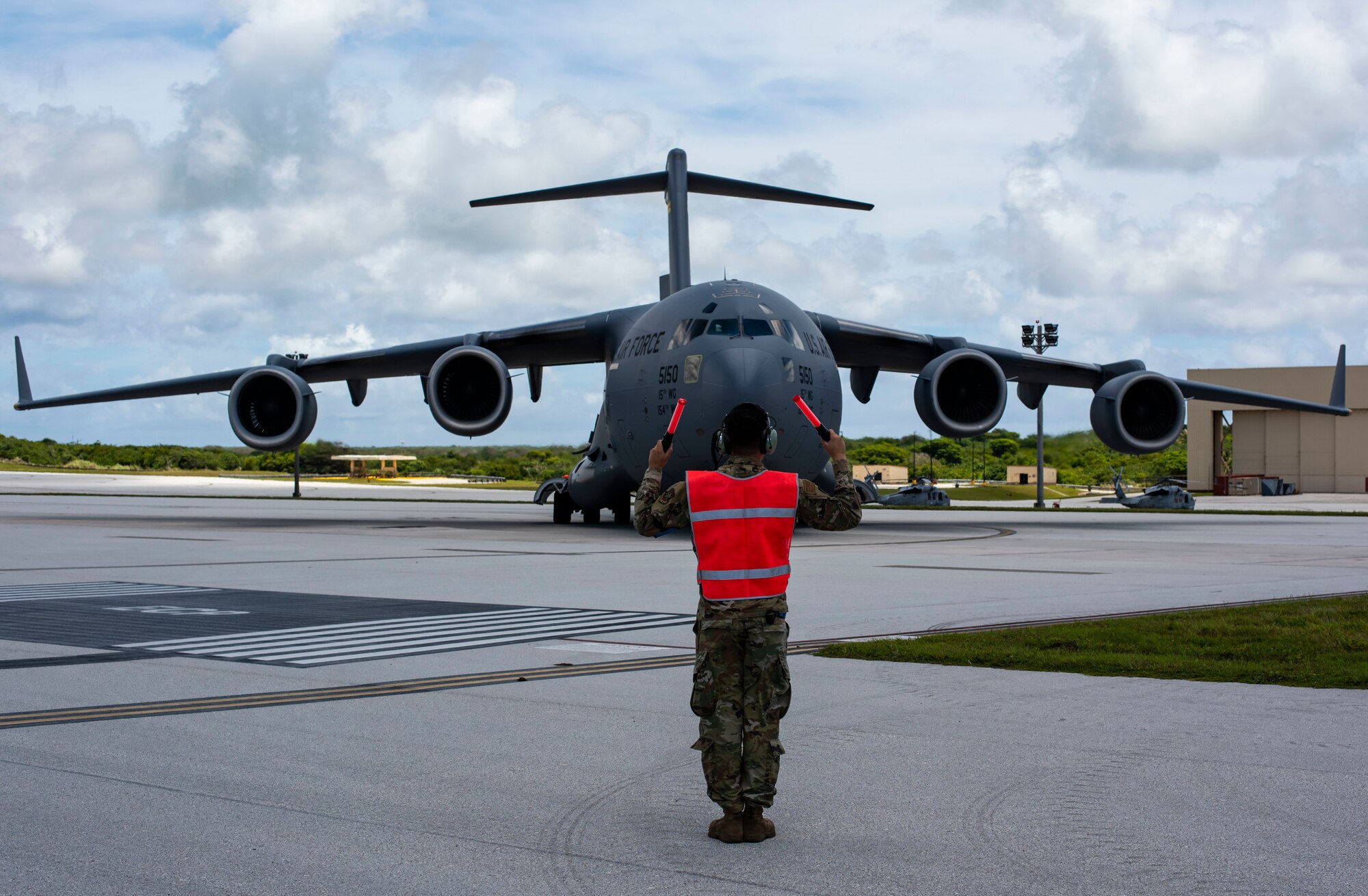 A C-17 Globemaster assigned to the 154th Wing, Hawaii Air National Guard, prepares to receive a post flight evaluation from Airmen assigned to the 734 Air Mobility Squadron after a Joint Forcible Entry Operation (JFEO) jump at Andersen Air Force Base, Guam, June 30.