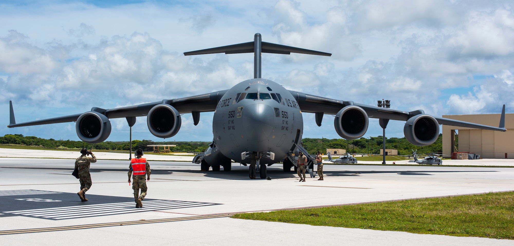 A C-17 Globemaster assigned to the 154th Wing, Hawaii Air National Guard, prepares to receive a post flight evaluation from Airmen assigned to the 734 Air Mobility Squadron after a Joint Forcible Entry Operation (JFEO) jump at Andersen Air Force Base, Guam, June 30.