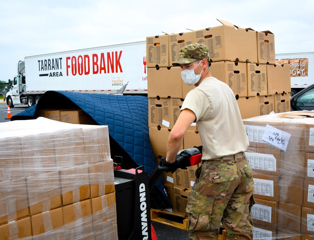 Guardsmen prepare family food boxes for distribution.