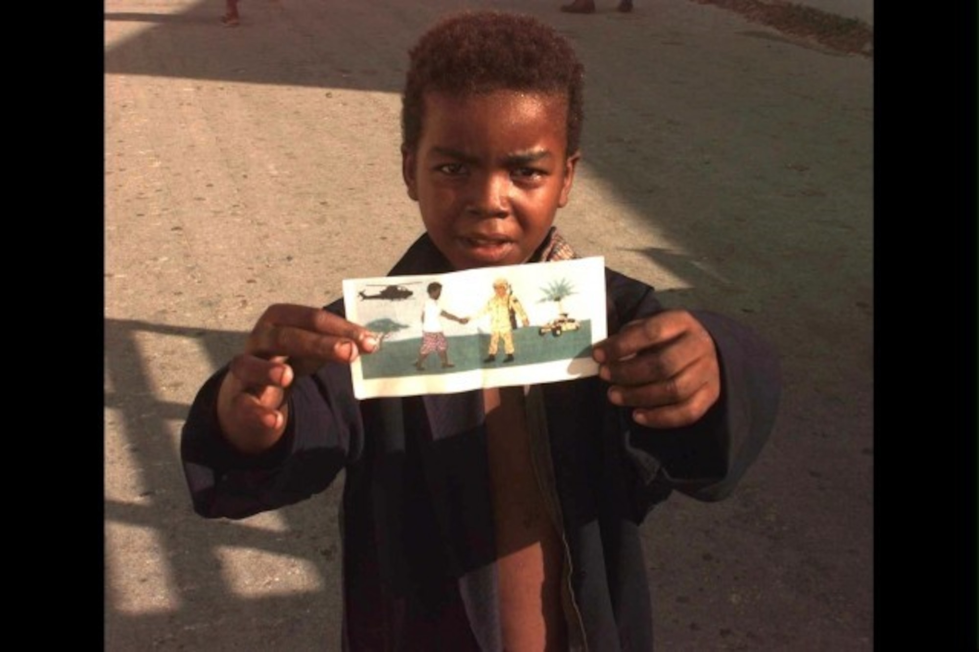 A Somali child holds the leaflet distributed during operation RESTORE HOPE. (U.S. Army photo)