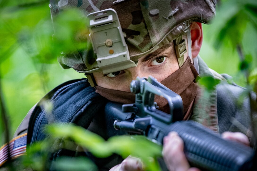 A soldier aims his weapon.