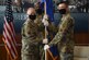 Lt. Col. Jason L. Coleman (right) receives the 316th guidon from Col. Tyler R. Schaff, 316th Wing and Joint Base Andrews commander (left), during an assumption of command ceremony at Joint Base Andrews, Md., July 8, 2020.