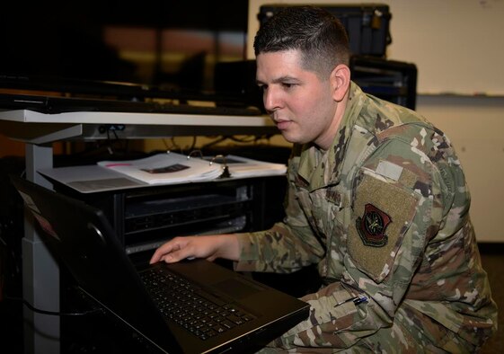 U.S. Air Force Staff Sgt. Cesar Torres, 60th Communications Squadron network control center technician, connects his laptop to the Cyberspace Vulnerability Assessment-Hunter to analyze data July 7, 2020, at Travis Air Force Base, California. The CVA-H is a tool designed to analyze or detect any possible threats within the Air Force’s network. (U.S. Air Force photo by Airman 1st Class Cameron Otte)