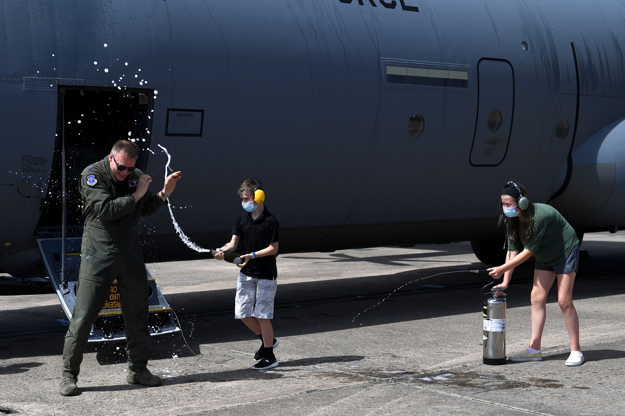 Col. Shane Haughian, 19th Operations Group commander, is sprayed by his family after exiting a C-130J Super Hercules upon completing his final flight as commander of the group at Little Rock Air Force Base, Arkansas, July 8, 2020. (U.S. Air Force photo by Senior Airman Kristine Gruwell)
