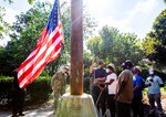 Newly restored flagpole flies the National Ensign over Norfolk Naval Shipyard.