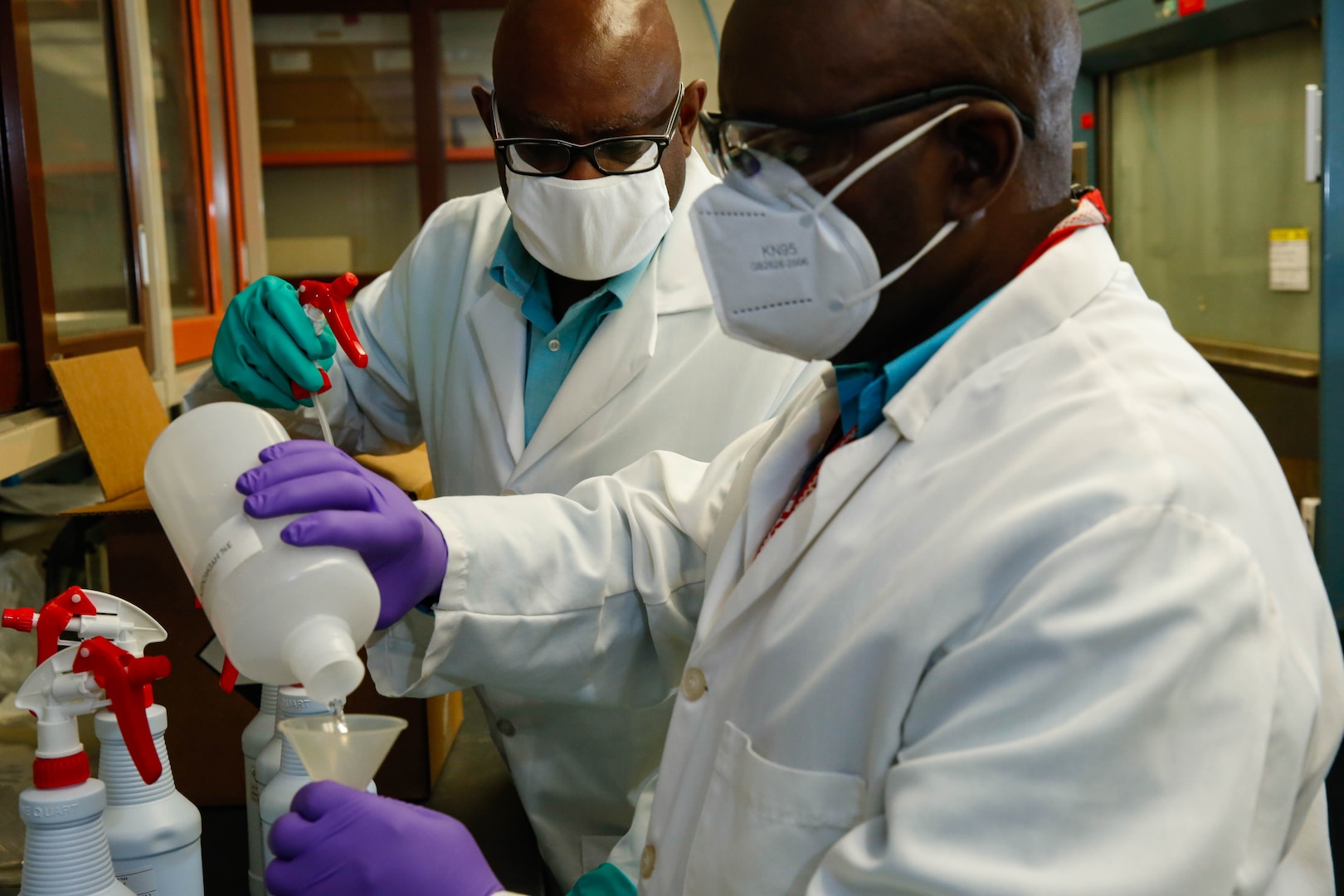 Mid-Atlantic Regional Materials Test Laboratory’s (Code 134) lab director Lyndon Clark and Senior Chemist Dickson Aweanung prepare hydrogen peroxide spray.