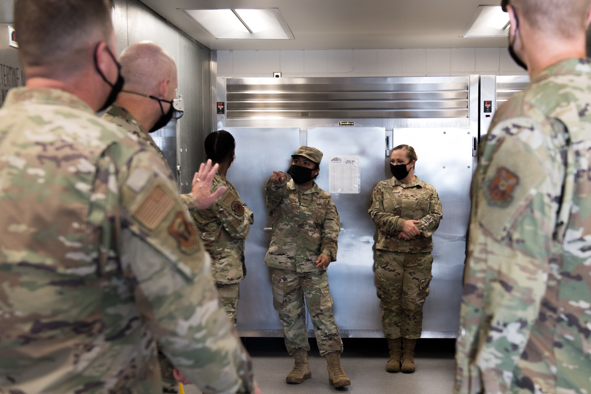 U.S. Air Force Tech. Sgt. Gretchen Sarmiento, 509th Force Support Squadron Touch & Go In-Flight Kitchen facility manager, leads a tour of the facility after a ribbon cutting ceremony at Whiteman Air Force Base, Missouri, June 29, 2020. The IFK renovations lasted for five months and include a custom built salad bar, marble counter tops, kitchen equipment and recessed lighting. (U.S. Air Force photo by Airman 1st Class Christina Carter)