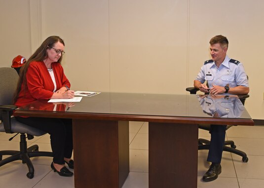 The 17th Training Group Director of Education Angelic Crawford, signs into effect theJames H. Doolittle Fellowship Program as U.S. Air Force Col. Thomas Coakley, 17th TRG commander, waits his turn to also sign at the Brandenburg Hall, on Goodfellow Air Force Base, Texas, June 16, 2020. Goodfellow was home to the infamous Doolittle Raiders in 1942, and carries on the memory by naming the scholarship as such. (U.S. Air Force Photo by Airman 1st Class Abbey Rieves)