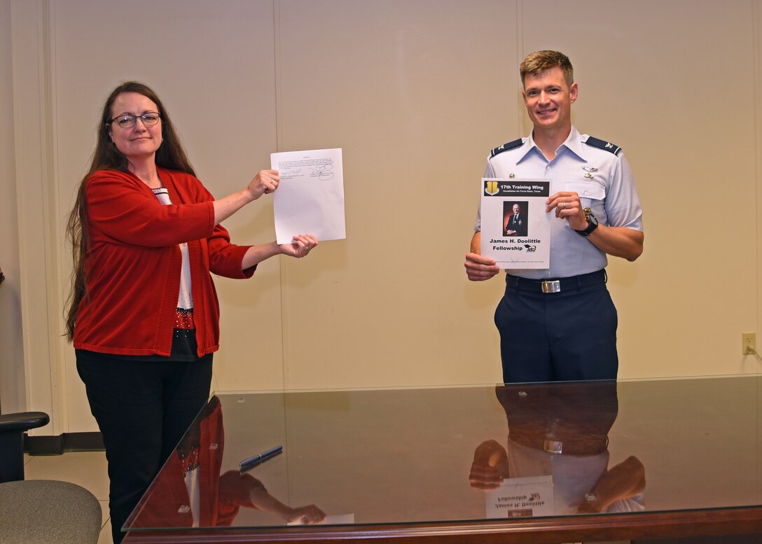 The 17th Training Group Director of Education Angelic Crawford and U.S. Air Force Col. Thomas Coakley, 17th TRG commander, presented the signed James H. Doolittle Fellowship Program memorandum of understanding at the Brandenburg Hall, on Goodfellow Air Force Base, Texas, June 16, 2020. This fellowship program supports the National Defense Strategy to build a more lethal and ready Air Force, by providing professional educators who deliver