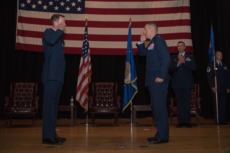 Lt. Col. Shannon Cummins, right, 22nd Communications Squadron outgoing commander, relinquishes command during a change of command ceremony July 8, 2020, at McConnell Air Force Base, Kansas. After two years at McConnell, Cummins’ next duty station is Maxwell Air Force Base, Alabama, where he will be an instructor at the Air Command Staff College. (U.S. Air Force photo by Senior Airman Alexi Bosarge)