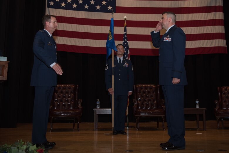 Lt. Col. James Hannon, right, 22nd Communications Squadron incoming commander, accepts command during a change of command ceremony July 8, 2020, at McConnell Air Force Base, Kansas. The change of command ceremony is a time-honored tradition that symbolizes the transfer of authority between leadership. (U.S. Air Force photo by Senior Airman Alexi Bosarge)