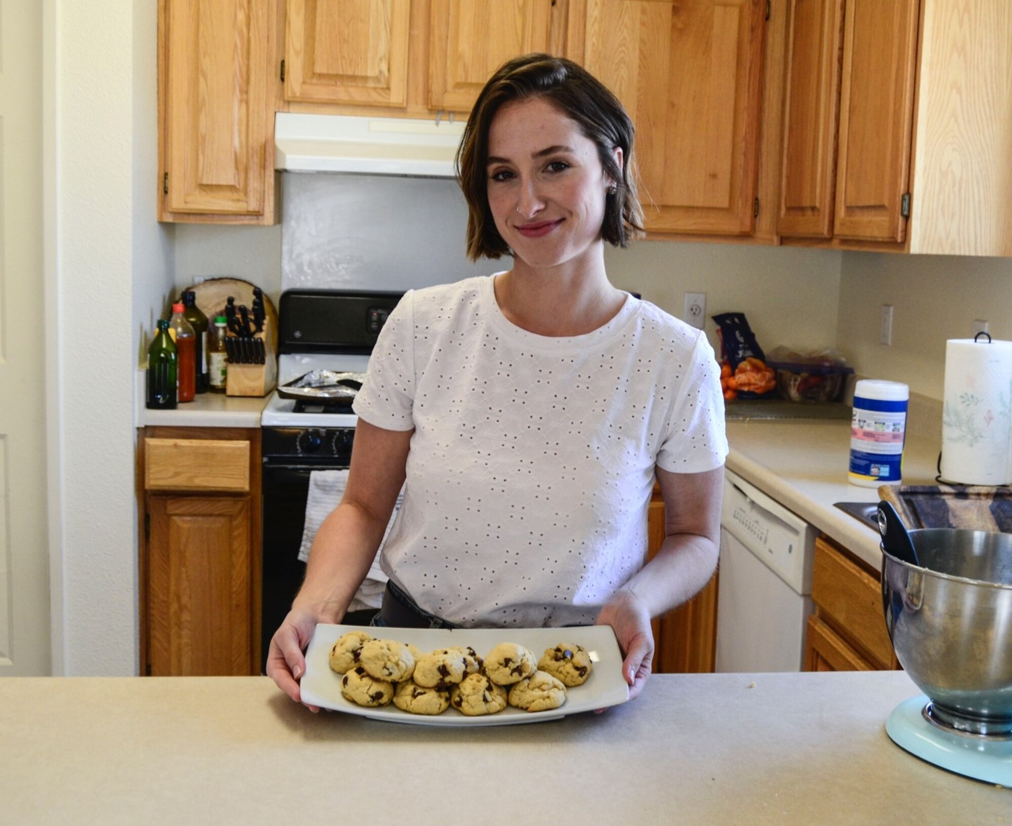 baker poses with her cookies