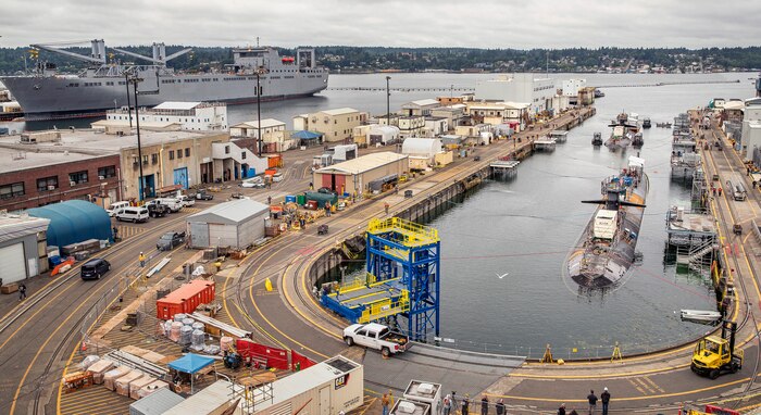 Los Angeles-class fast-attack submarines USS Louisville (SSN-724), foreground, and USS Olympia (SSN-717) are moved into Dry Dock 5 July 9, 2020 to begin the inactivation process at Puget Sound Naval Shipyard & Intermediate Maintenance Facility in Bremerton, Washington.