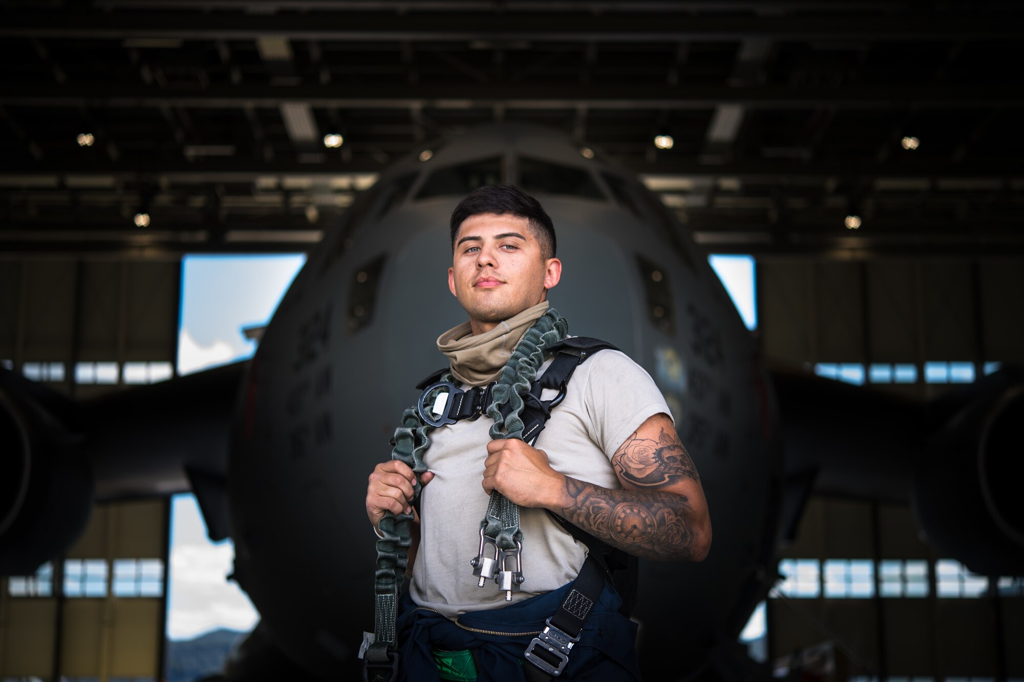 Photo of Airman in front of aircraft