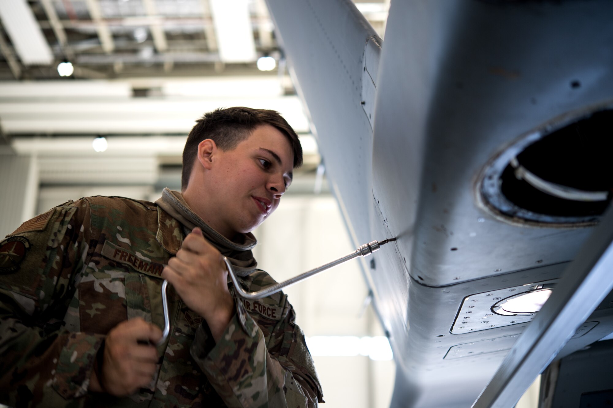 Photo of Airman performing aircraft maintenance