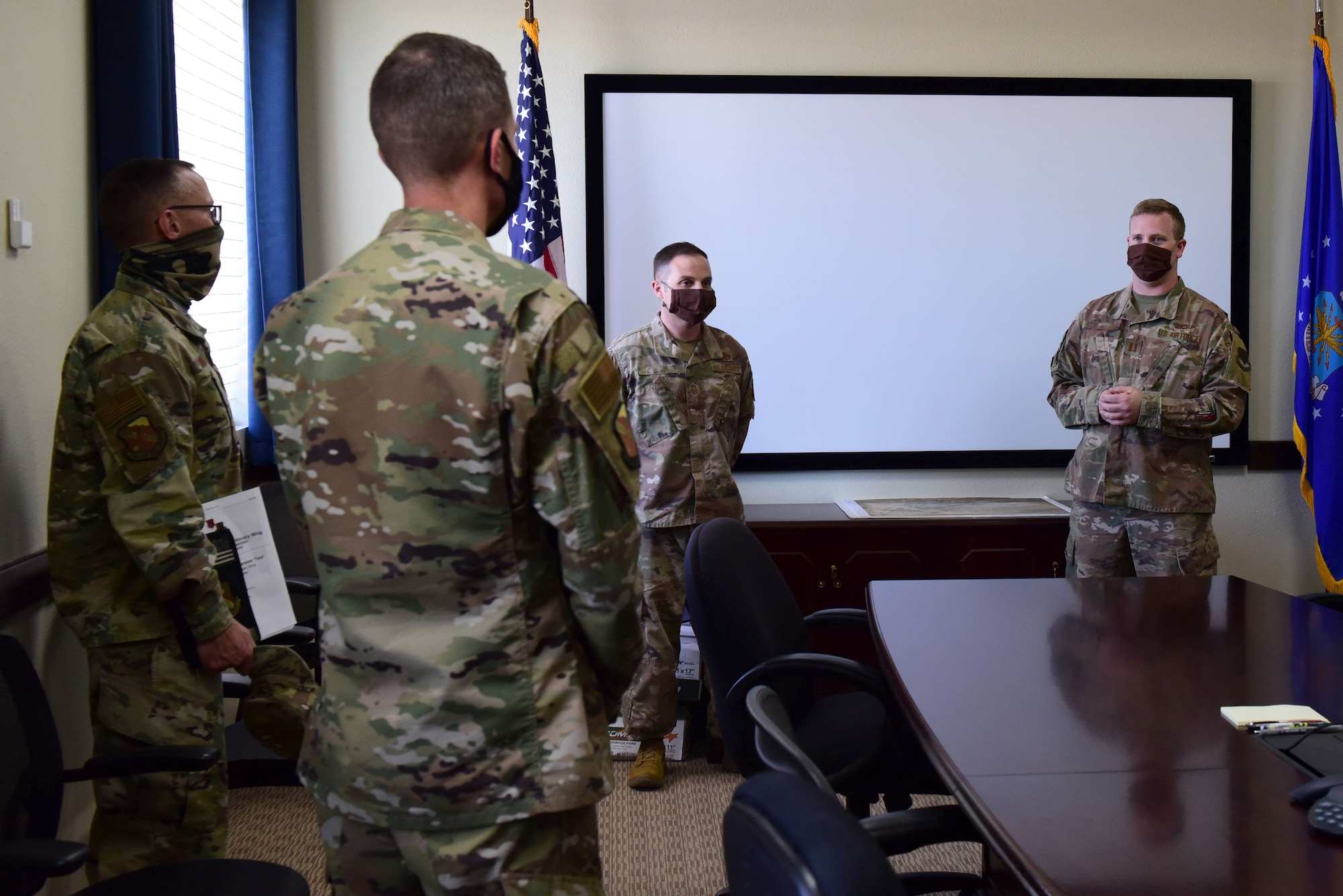 Civil Engineering Airmen brief 99th Air Base Wing Leadership in a conference room.