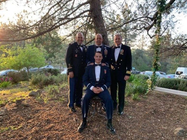 Four Cooper family members take a group photo. All four are in uniform and served at one point in their lives presenting more than 70 years of military service.