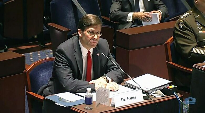 A man speaks into a microphone.