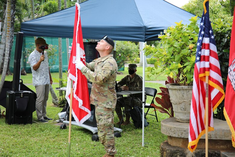 Incoming Pacific Ocean Division Command Sgt. Maj. Douglas W. Galick prepares to place the division colors during a Change of Command and Responsibility Ceremony on Fort Shafter, Hawaii, July 8.