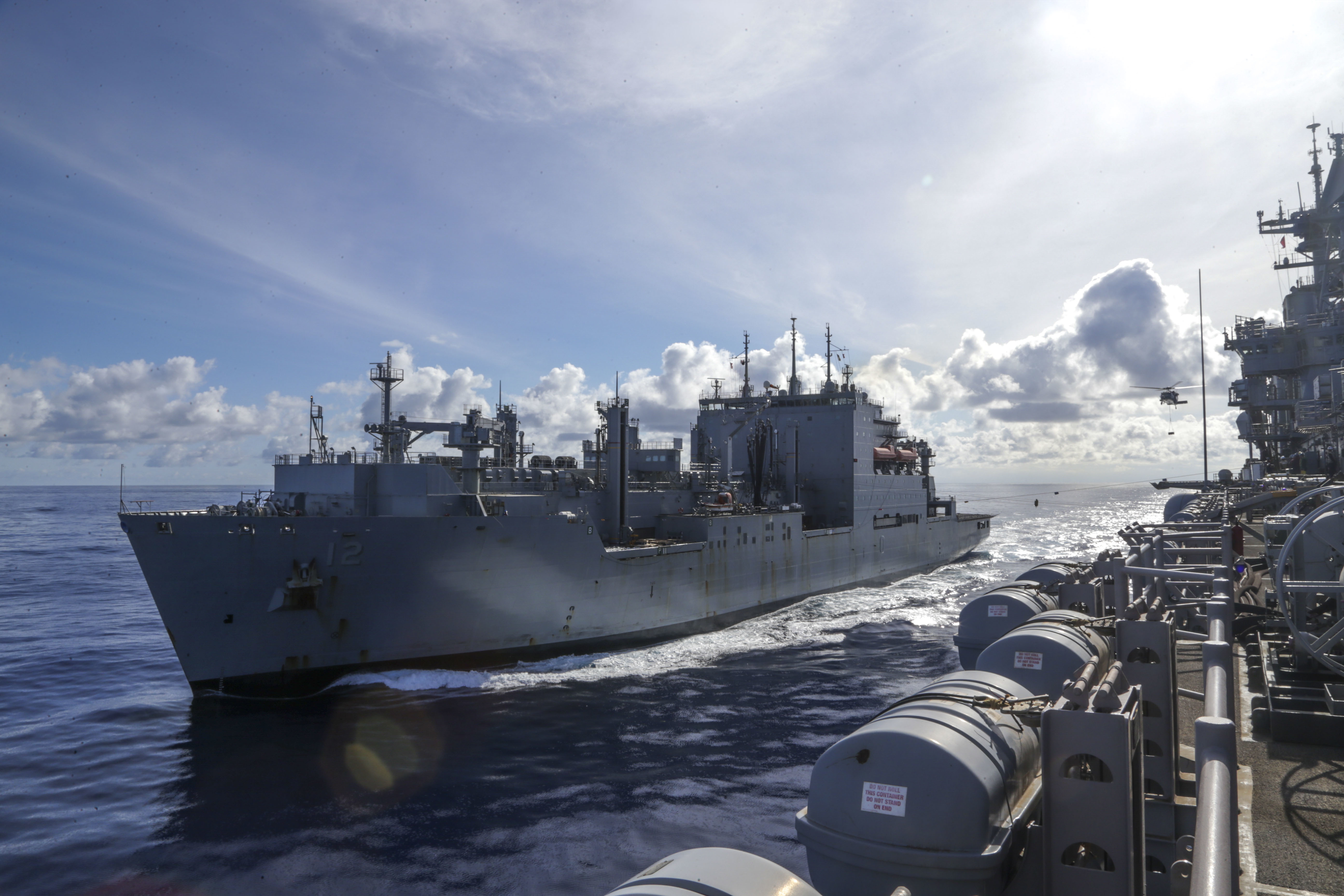 USNS William McLean (T-AKE 12) transits alongside the amphibious assault ship USS Bataan (LHD 5)